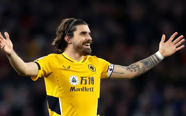 HD desktop wallpaper featuring Rúben Neves in Wolverhampton Wanderers F.C. soccer jersey with arms outstretched during a match.