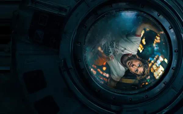 4K Ultra HD wallpaper featuring Ryan Gosling in a space module scene from the movie Project Hail Mary, viewed through a circular window with reflections.