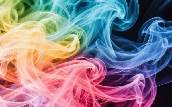 Vibrant swirling colorful smoke in red, yellow, green, and blue hues against a dark background, captured in stunning 4K Ultra HD for a dynamic PC desktop wallpaper.