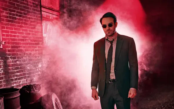 HD PC desktop wallpaper featuring Daredevil in a suit and sunglasses, standing against a red-lit smoky urban backdrop.