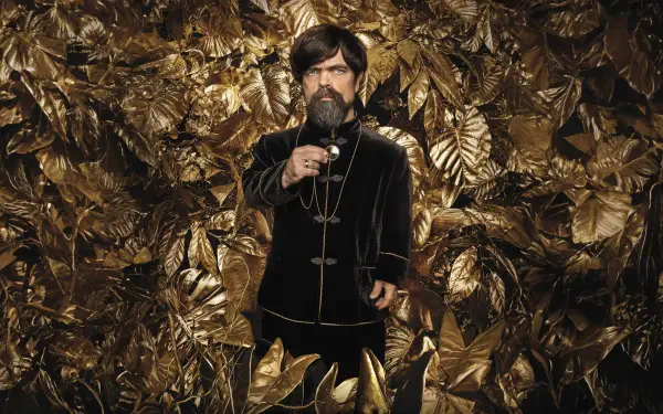 8K Ultra HD PC desktop wallpaper: a velvet-clad man raising a glass amid shimmering golden leaves, themed to The Hunger Games: The Ballad of Songbirds & Snakes.