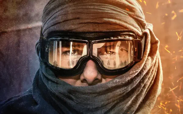Masked agent close-up in goggles and wrapped scarf amid flying sparks — Mission: Impossible - Dead Reckoning Part One 4K Ultra HD PC desktop wallpaper and background.