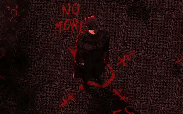 The Batman in a black cape stands on a dark metal grid floor scrawled with red graffiti reading NO MORE — 4K Ultra HD PC desktop wallpaper/background.
