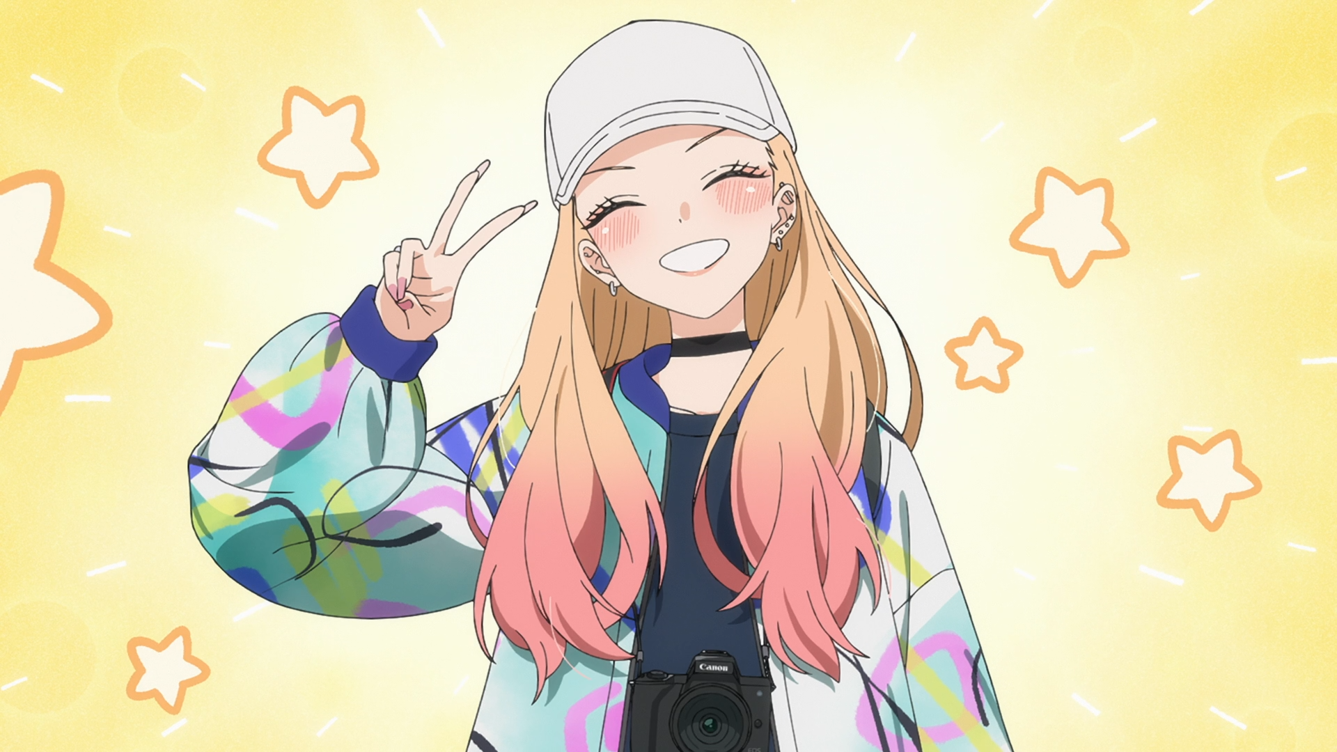 Marin Kitagawa (My Dress-Up Darling) smiling and flashing a peace sign, wearing a cap and colorful jacket against a starry yellow backdrop — HD PC desktop wallpaper.