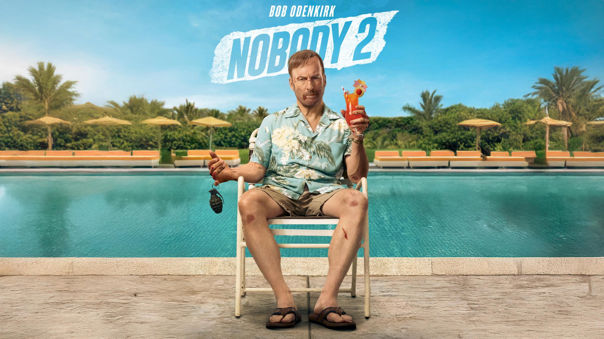 8K Ultra HD PC wallpaper: Nobody 2 logo over a man in a Hawaiian shirt seated by a pool with a cocktail and sunglasses, palm trees and a bright blue sky in the background.