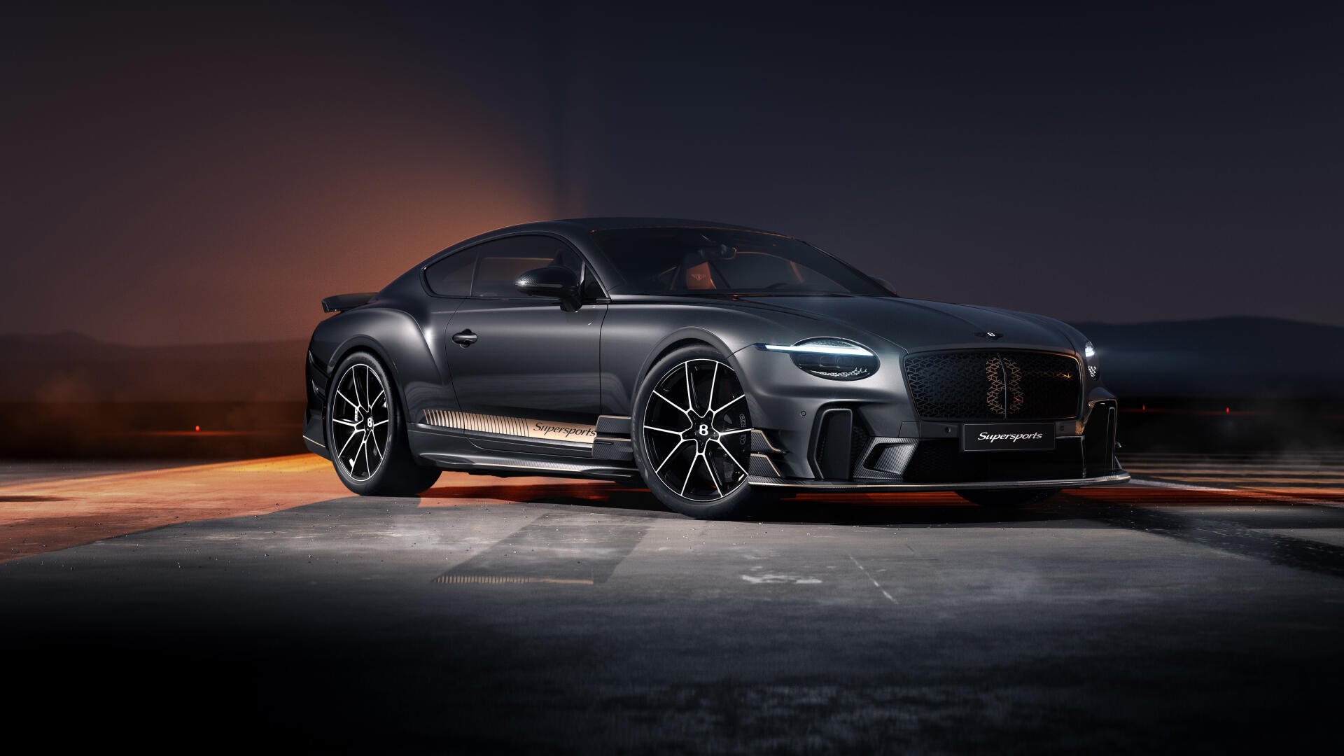 Black Bentley Continental GT luxury car on dimly lit tarmac, glossy body and sporty wheels — 5K Ultra HD desktop wallpaper/background.