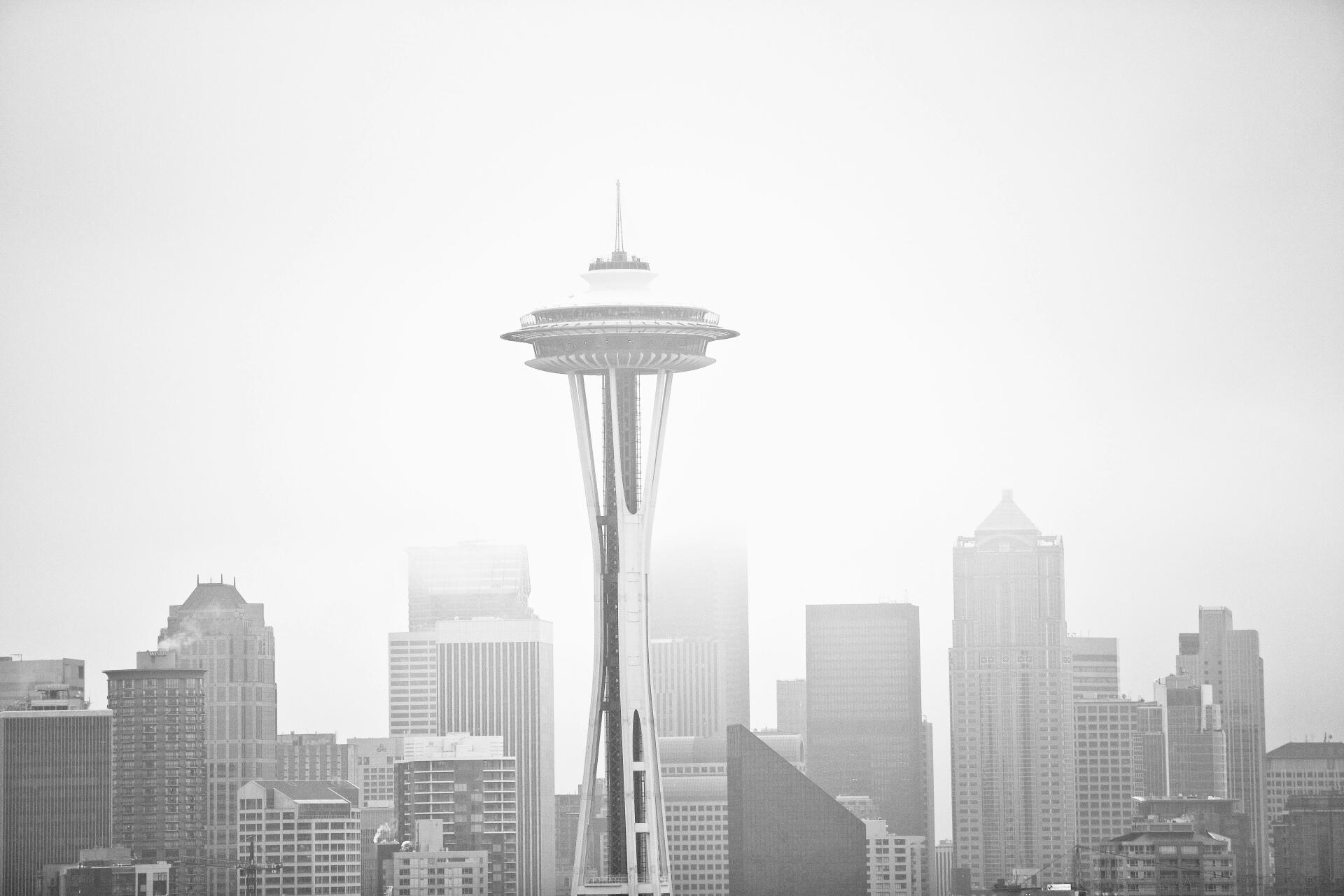 Monochrome 5K Ultra HD photography of the Seattle skyline with the Space Needle centered against a white sky, PC desktop wallpaper/background.