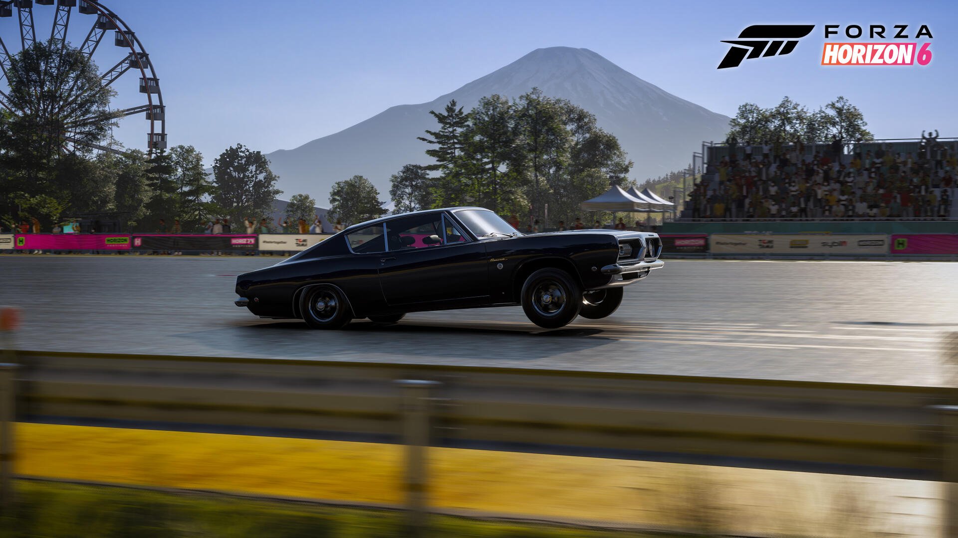 Forza Horizon 6 video game 4K Ultra HD PC desktop wallpaper: black classic muscle car racing on a sunlit track with ferris wheel, trees and a distant mountain.