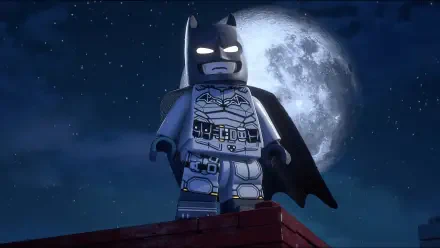 Video game scene: Lego Batman from Lego Batman: Legacy of the Dark Knight stands on a rooftop at night beneath a full moon — 4K Ultra HD PC desktop wallpaper.