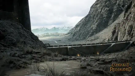 4K Ultra HD PC desktop wallpaper of Helm's Deep from the movie The Lord of the Rings: The Two Towers, fortress walls spanning a rain‑swept mountain gorge under grey skies.