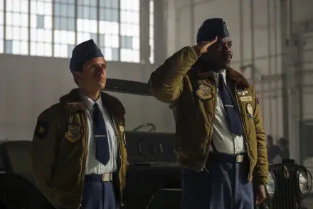 HD PC desktop wallpaper: two uniformed officers in a hangar, one saluting, both with surprised expressions — scene from the TV show It: Welcome to Derry.
