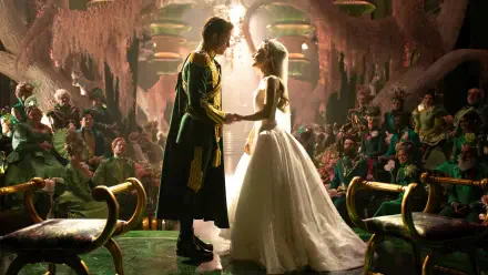 Movie 'Wicked: For Good' 4K Ultra HD PC desktop wallpaper background: two characters in wedding attire hold hands beneath a shaft of light in an ornate, crowded, candlelit hall.