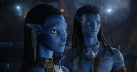 HD PC desktop wallpaper and background from the movie Avatar: Fire and Ash showing two blue-skinned Na'vi: a focused female with braided hair and jewelry, and a blurred male behind her.