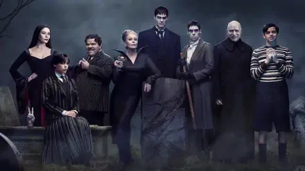 HD PC desktop wallpaper: moody gothic family portrait featuring Wednesday and her eerie relatives standing amid fog under a slate-blue sky.