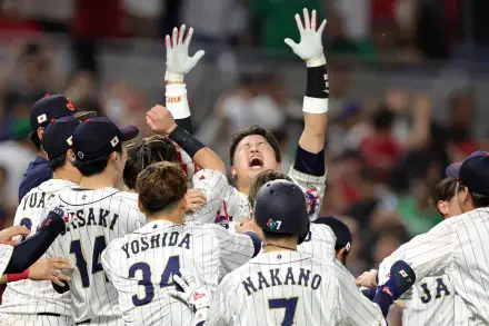 World Baseball Classic HD PC desktop wallpaper: pinstriped baseball team celebrating on field, players raising arms and cheering before a blurred stadium crowd.
