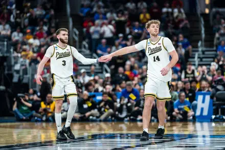 NCAA Purdue Boilermakers basketball players high-fiving on the court, action shot as an HD PC desktop wallpaper and background.