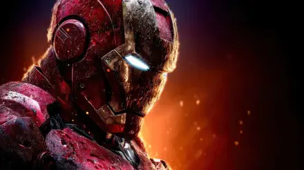Digital art 5K Ultra HD wallpaper: close-up of Iron Man's battle-scarred mask with glowing eyes and scorched red-gold armor — Marvel Comics superhero on a PC desktop background.