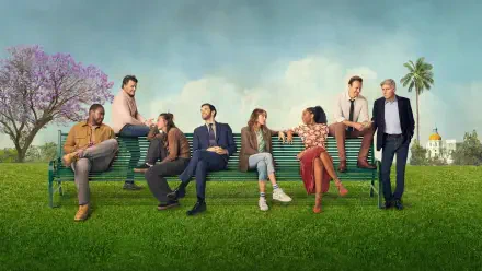 Wallpaper Shrinking — 4K Ultra HD PC desktop background of eight people on an oversized park bench across a green lawn beneath blue sky, with a flowering tree and distant palm-lined building.
