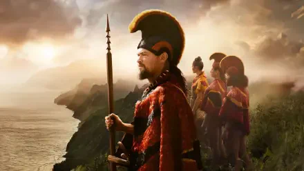 Chief of War: a stoic chief in a red cloak holding a spear as guards stand on a coastal cliff at sunrise — 4K Ultra HD PC Desktop Wallpaper and Background.