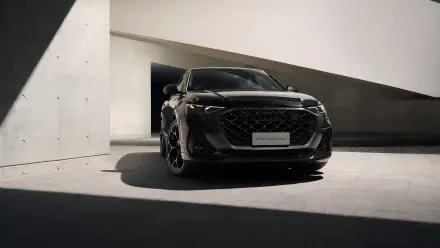Black Audi RS Q8 SUV in dramatic shadowed modern architectural garage, presented as a 5K Ultra HD PC desktop wallpaper.