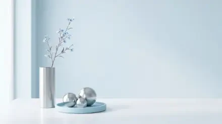 Clean minimalist 5K Ultra HD PC desktop wallpaper and background: pale blue wall, white surface, slender silver vase with delicate branches and three reflective spheres on a blue tray.