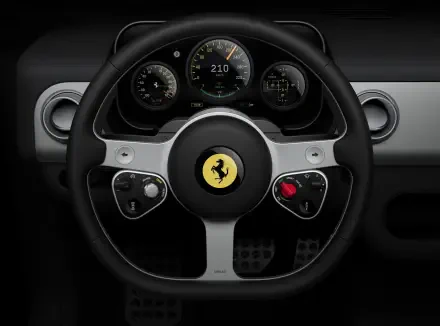 Ferrari Luce vehicle steering wheel with prancing horse emblem and illuminated dashboard gauges — 4K Ultra HD PC desktop wallpaper/background.