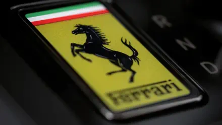 Close-up of Ferrari prancing horse badge with Italian tricolor and Ferrari Luce text — 4K Ultra HD PC desktop wallpaper/background featuring the vehicle emblem.
