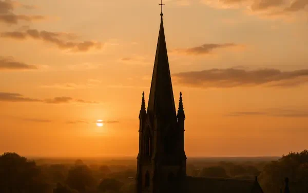 Black spire silhouette against a golden sunset over a flat horizon, 4K Ultra HD PC desktop wallpaper and background.