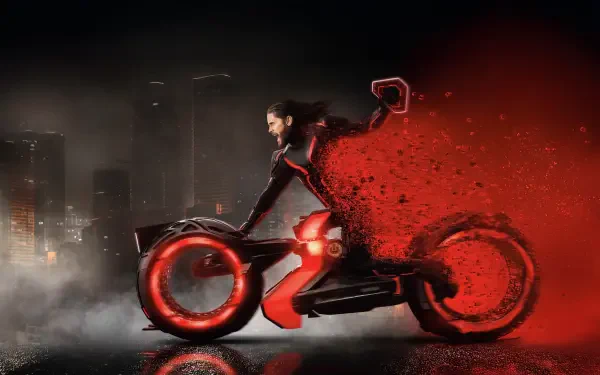 Tron: Ares 4K Ultra HD PC desktop wallpaper — rider on a red-glowing lightcycle streaks through red particle trails with a neon-lit city skyline in the background.