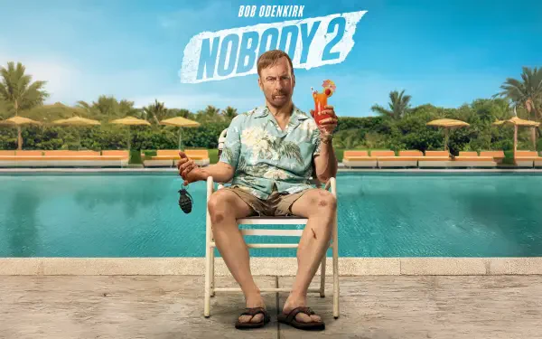 8K Ultra HD PC wallpaper: Nobody 2 logo over a man in a Hawaiian shirt seated by a pool with a cocktail and sunglasses, palm trees and a bright blue sky in the background.
