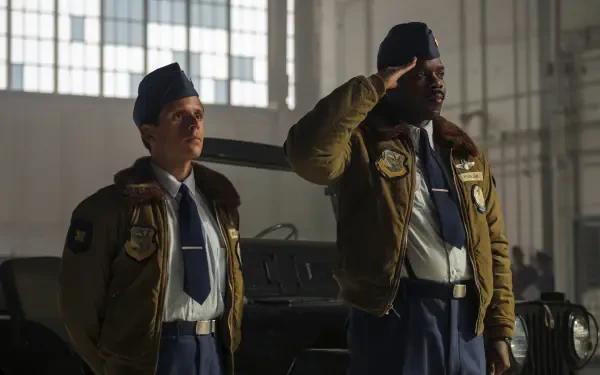 HD PC desktop wallpaper: two uniformed officers in a hangar, one saluting, both with surprised expressions — scene from the TV show It: Welcome to Derry.