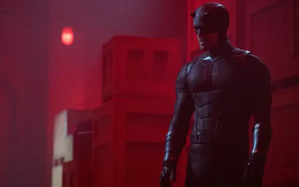 Daredevil from Daredevil: Born Again standing in a red-lit hallway in his suit — 8K Ultra HD TV show PC desktop wallpaper/background.
