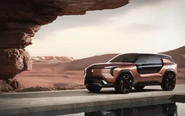 Mitsubishi Elevance concept SUV parked by desert rock formation, rendered in 8K Ultra HD as a PC desktop wallpaper/background.