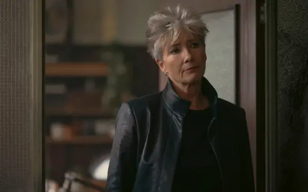 Gray-haired woman in a dark leather jacket stands in a doorway inside a dim room — 5K Ultra HD PC desktop wallpaper for TV show Down Cemetery Road, featuring the lead actress.