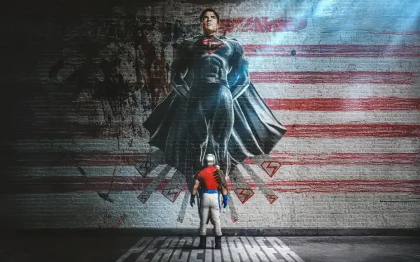 Peacemaker (Tv Show) 5K Ultra HD PC desktop wallpaper: Peacemaker stands beneath a towering painted Superman against a distressed American-flag mural, bathed in dramatic light and gritty texture.