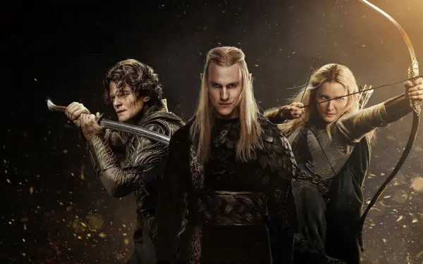Three elven warriors: a stern central leader with a swordsman and an archer at his sides in a dark, cinematic scene. The Lord of the Rings: The Rings of Power — 4K Ultra HD PC desktop wallpaper.