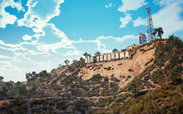 HD PC desktop wallpaper for the video game Showa American Story: sunlit hillside with a Neo Yokohama sign, radio towers and scrub under a bright, cloud-streaked blue sky.