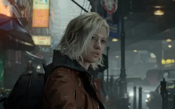 Grace Ashcroft (Resident Evil Requiem) 4K Ultra HD PC desktop wallpaper: her in a rain-soaked urban nightscape, short blond hair and a brown jacket.