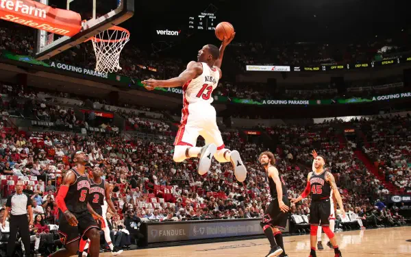 HD PC desktop wallpaper/background: NBA basketball action as a Miami Heat player soars for a thunderous dunk in a packed arena.