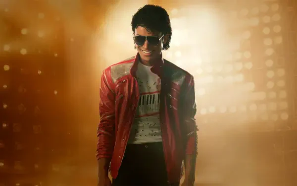 Wallpaper titled Michael (2026): stylized figure in a red jacket and sunglasses bathed in golden light — 5K Ultra HD PC desktop wallpaper and background.