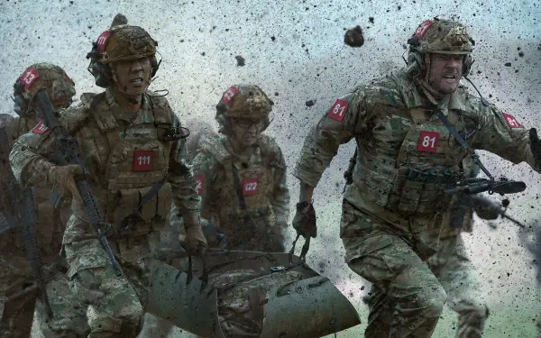 War Machine (2026) 4K Ultra HD PC desktop wallpaper: four battle-worn soldiers sprinting through debris, carrying a stretcher amid explosions and flying rubble.