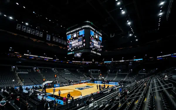 HD PC desktop wallpaper and background: wide-angle shot of an NCAA basketball arena featuring the Purdue Boilermakers court, empty stands, and a central scoreboard under arena lighting.