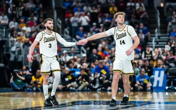 NCAA Purdue Boilermakers basketball players high-fiving on the court, action shot as an HD PC desktop wallpaper and background.