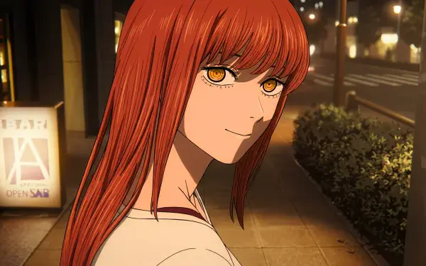 5K Ultra HD wallpaper of Makima (Chainsaw Man): red-haired anime devil girl glancing over her shoulder on a warmly lit city sidewalk at night.