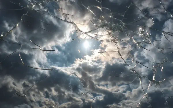 2K Quad HD PC desktop wallpaper/background: sunlit cloudy sky seen through cracked glass and a broken screen, cracks radiating from the center.