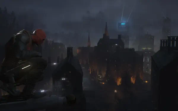 Red Hood from the Gotham Knights video game crouches on a rain‑slick rooftop overlooking a foggy, neon‑lit Gotham skyline, 4K Ultra HD PC desktop wallpaper and background.