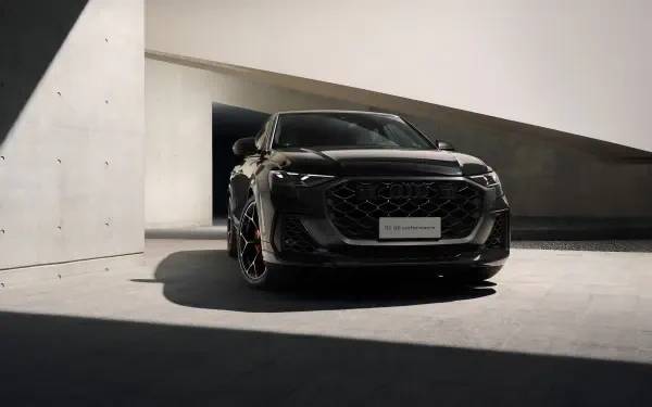 Black Audi RS Q8 SUV in dramatic shadowed modern architectural garage, presented as a 5K Ultra HD PC desktop wallpaper.