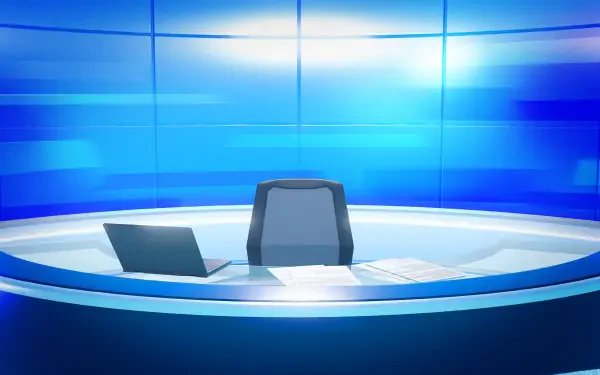 Tomodachi Life: Living the Dream HD PC desktop wallpaper — a futuristic blue broadcast desk with an empty anchor chair, laptop and papers against a glowing tiled backdrop.