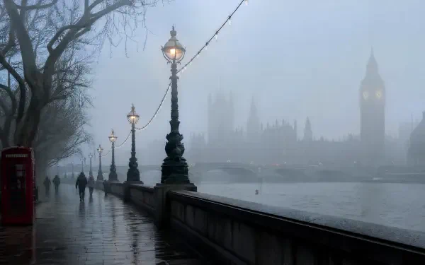 Foggy morning riverside promenade with ornate lampposts, silhouetted pedestrians and a faint clock tower across the mist, 4K Ultra HD PC desktop wallpaper.