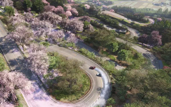 Aerial view of winding mountain road lined with pink blossom trees, sports cars drifting — Forza Horizon 6 4K Ultra HD PC desktop wallpaper/background.